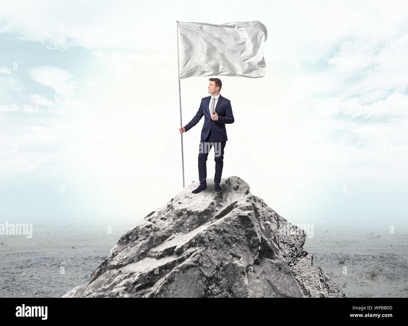Handsome businessman on the top of the mountain with white flag Stock ...