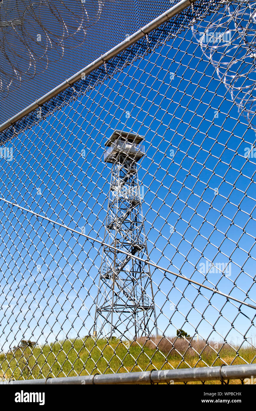 Prison security guard tower,  overlooking security fence. Stock Photo