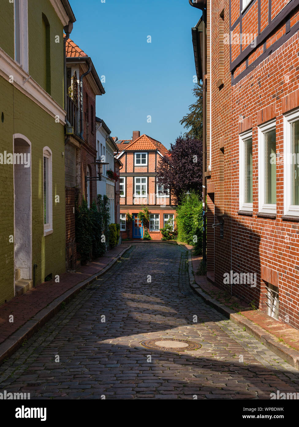 View at cobblestone street in historical center of Stade, Germany at a sunny day. A big tourist attraction. Stock Photo
