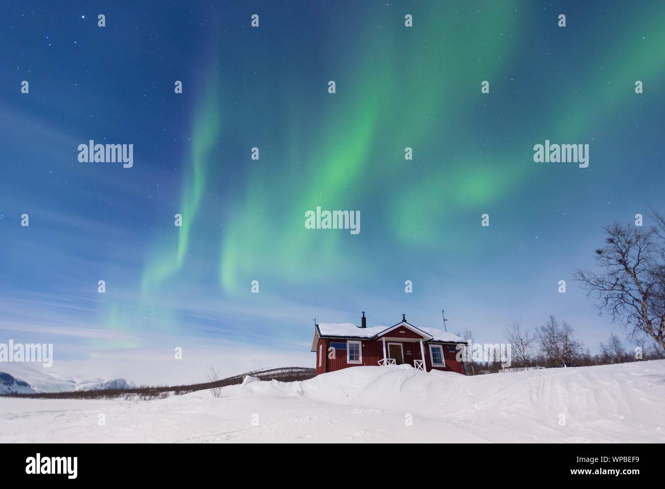 Northern Lights Aurora Borealis Above A Swedish Red House In Winter