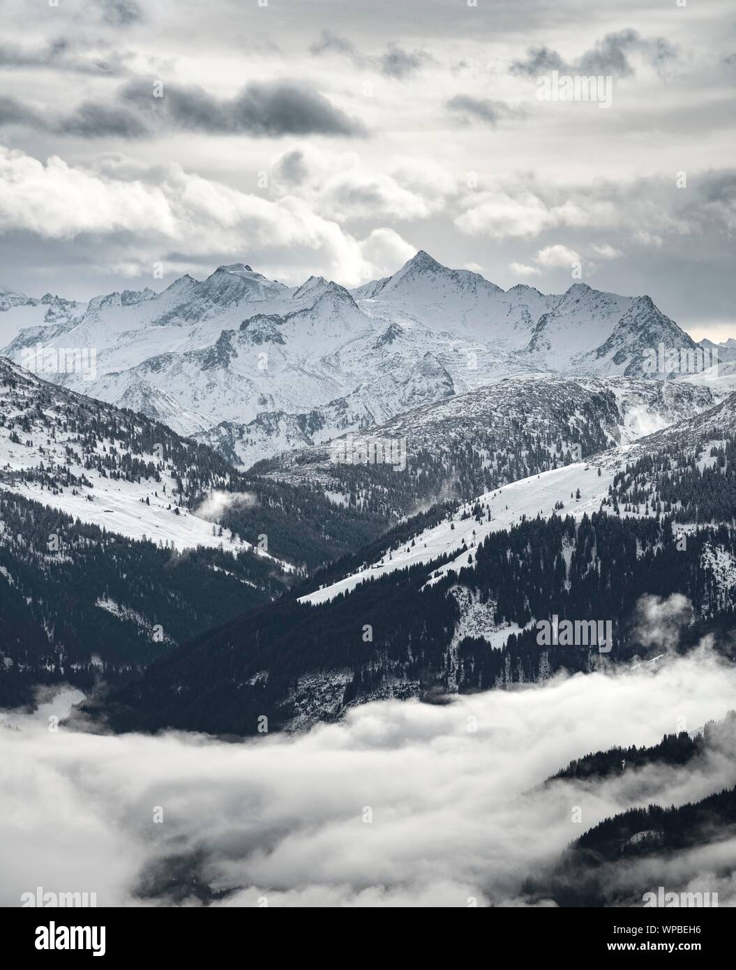 View of snow-covered main Alpine ridge with Grossvenediger, high fog in the valley, Hochbrixen, Brixen im Thale, Brixental, Tyrol, Austria Stock Photo