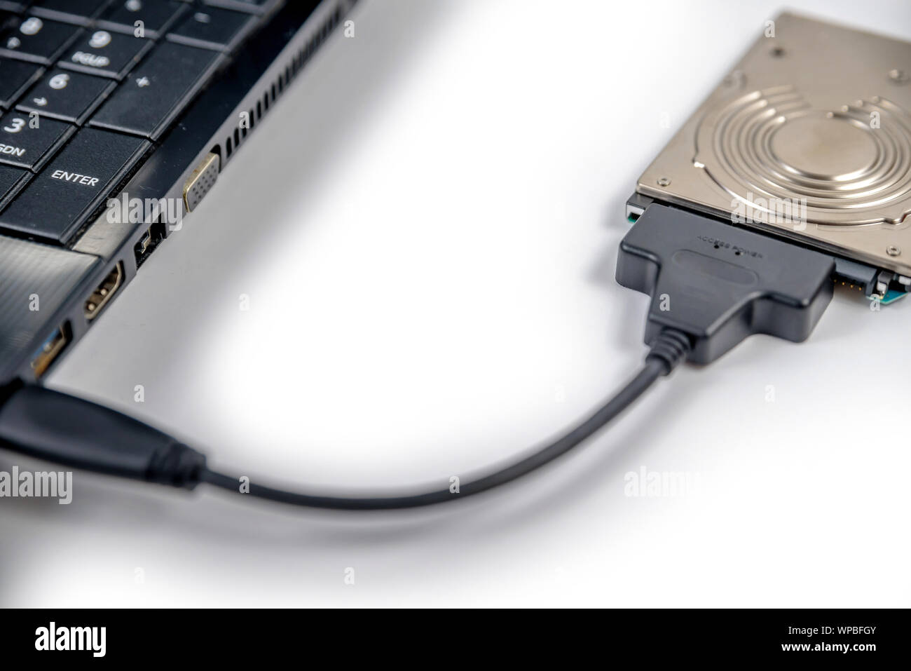hdd 2.5 internal hard drive disk connected to laptop via sata usb cable  closeup view Stock Photo - Alamy