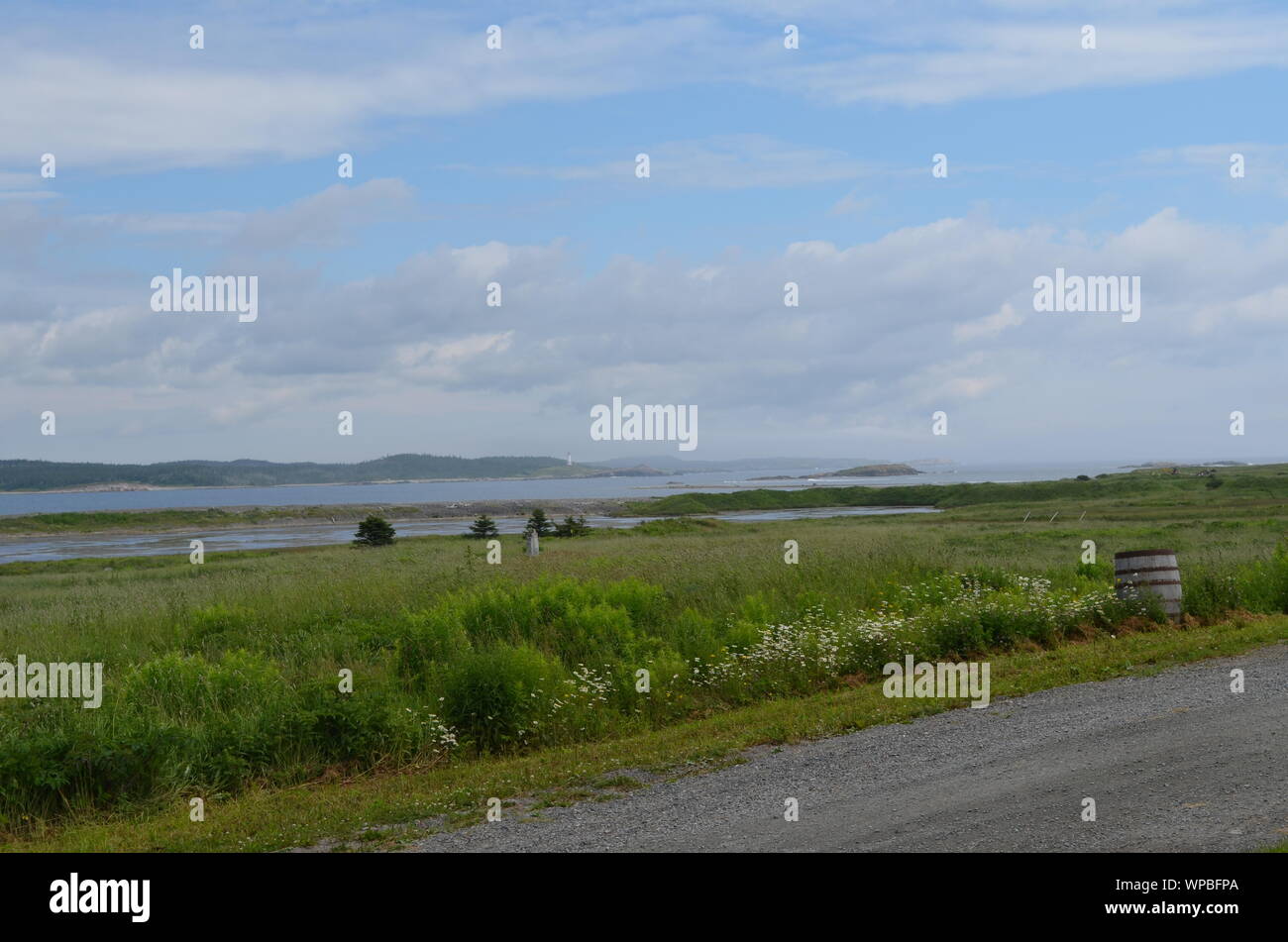 Summertime in Nova Scotia: Louisbourg Lighthouse, Salmon Rock and Battery Island on Cape Breton Island Stock Photo