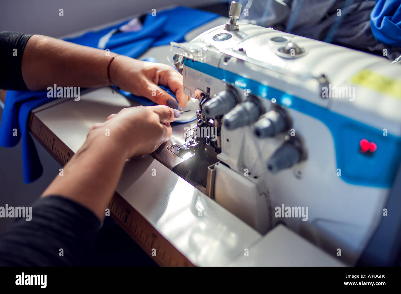 Tailoring Machine Work A tailor works with sewing machine. Manufacture of wearing concept ...