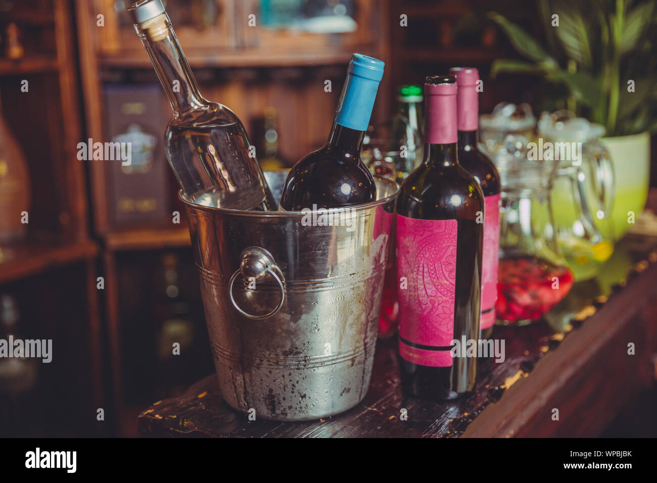 Expensive chilled champagne bottles in a metal bowl on ice standing on
