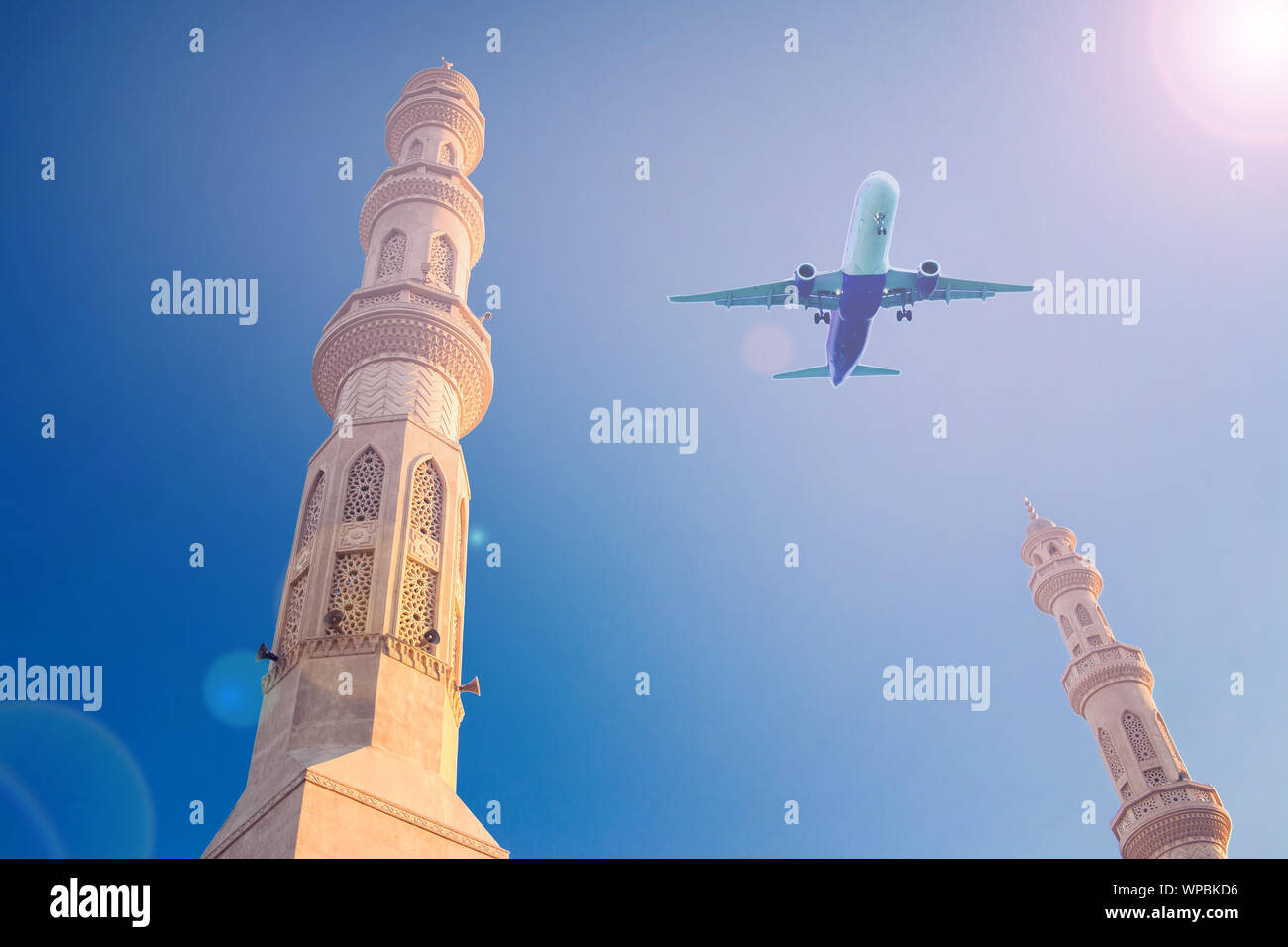 Plane in the sky over mosque. Holiday and travel concept Stock Photo