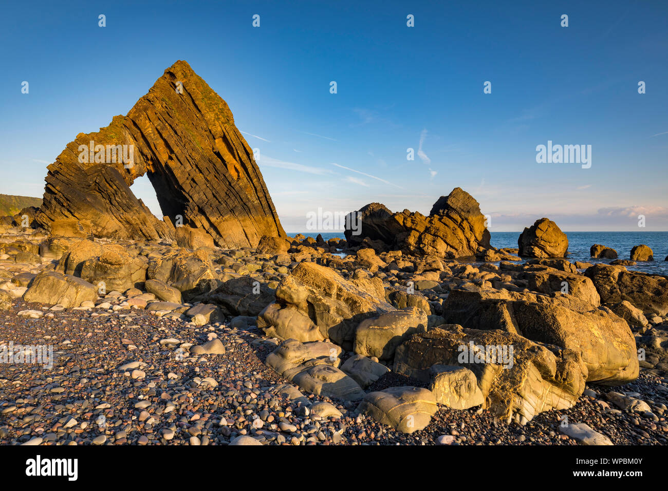 Blackchurch Rock, Mouthmill beach, North  Devon coastline at sunrise with blue sky Stock Photo