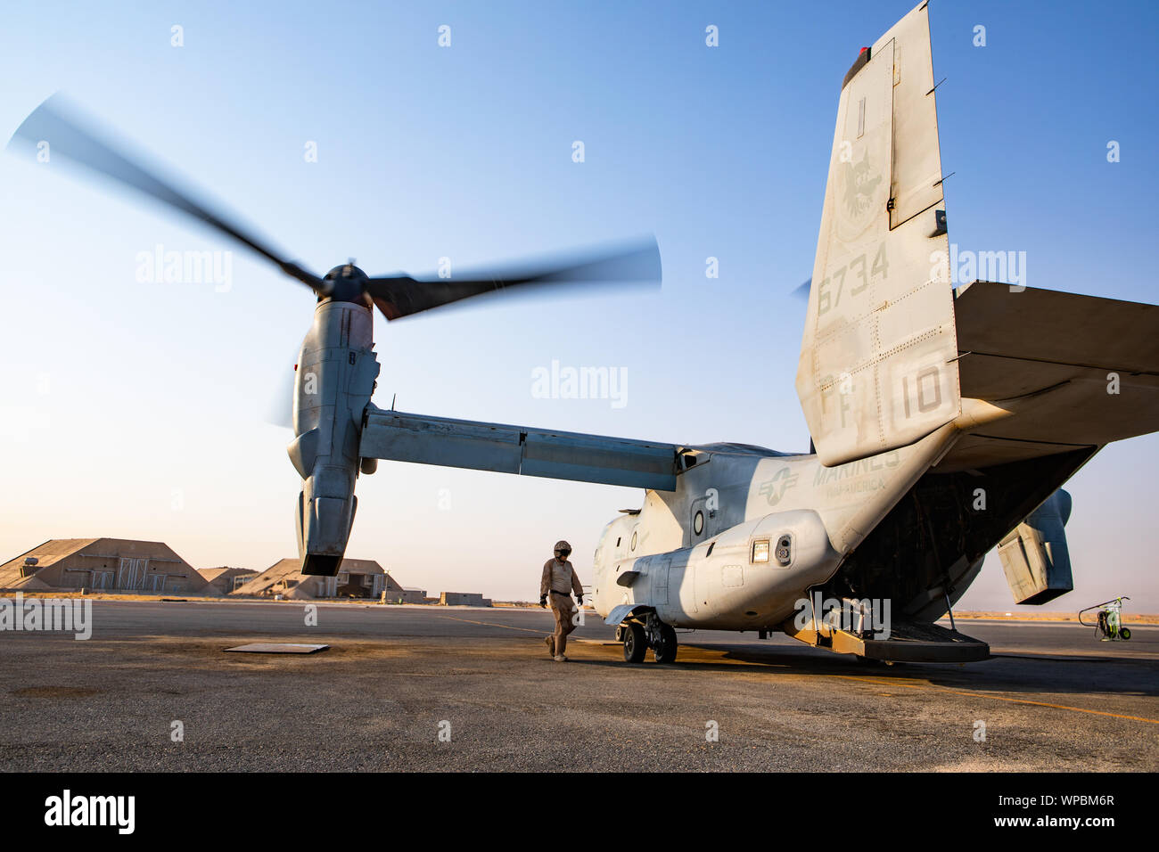 A crew chief with Marine Medium Tiltrotor Squadron (VMM) 364, attached to Special Purpose Marine Air-Ground Task Force-Crisis Response- Air Combat Element 19.2, inspects a MV-22 Osprey prior to a logistics mission in Kuwait, Sept. 4, 2019. A Marine Air Ground Task Force is specifically designed to be capable of deploying aviation, ground, and logistics forces forward at a moment’s notice. (U.S. Marine Corps photo by Sgt. Kyle C. Talbot) Stock Photo