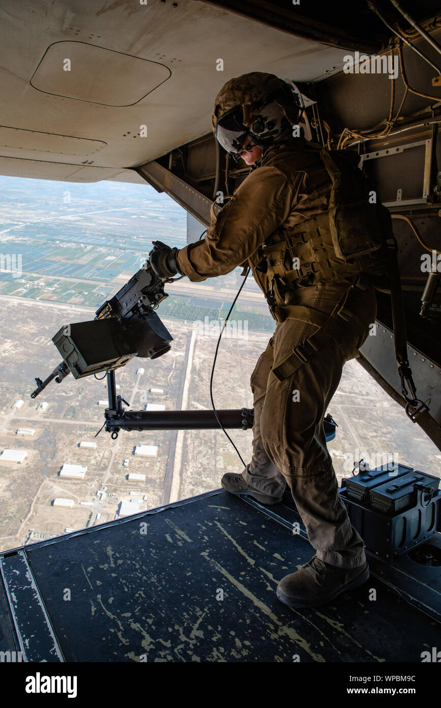A crew chief with Marine Medium Tiltrotor Squadron (VMM) 364, attached to Special Purpose Marine Air-Ground Task Force-Crisis Response- Air Combat Element 19.2, mans a M240-D machine gun on a MV-22 Osprey during a logistics mission in an undisclosed location, Sept. 4, 2019. A Marine Air Ground Task Force is specifically designed to be capable of deploying aviation, ground, and logistics forces forward at a moment’s notice. (U.S. Marine Corps photo by Sgt. Kyle C. Talbot) Stock Photo