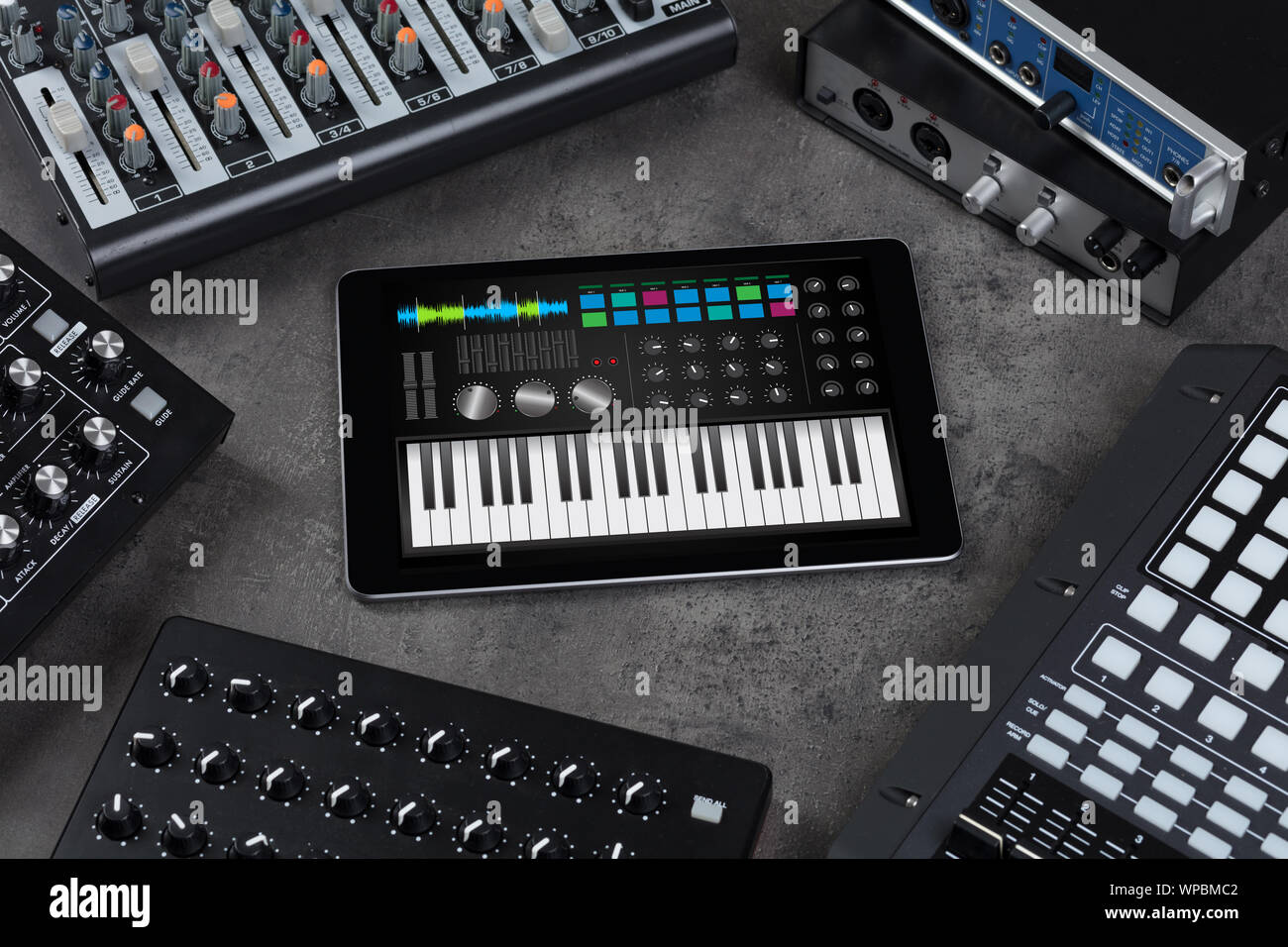 Piano synthesizer app on tablet and musical instrument concept Stock