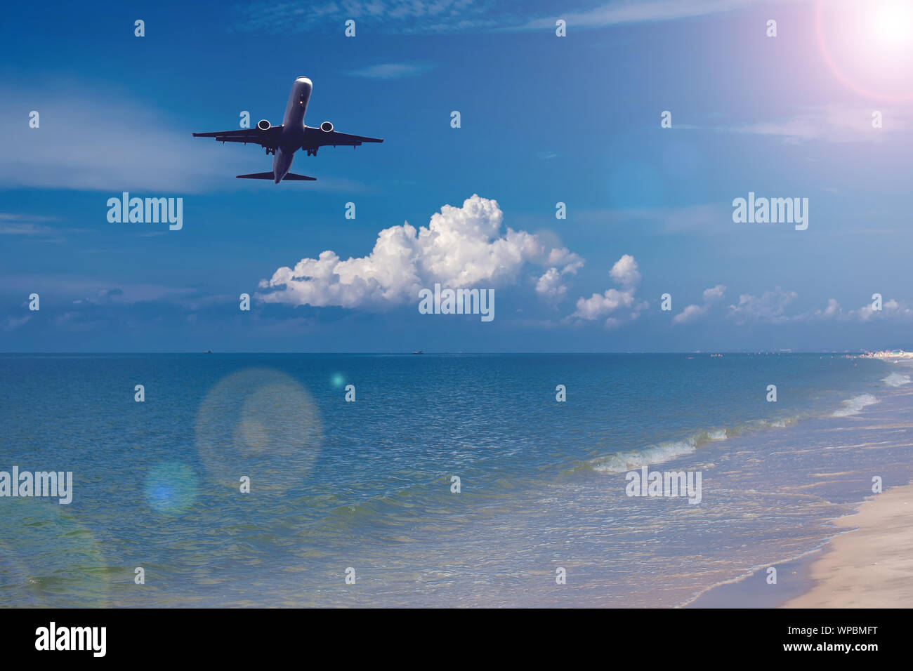Plane in the sky over sea. Holiday and travel concept Stock Photo