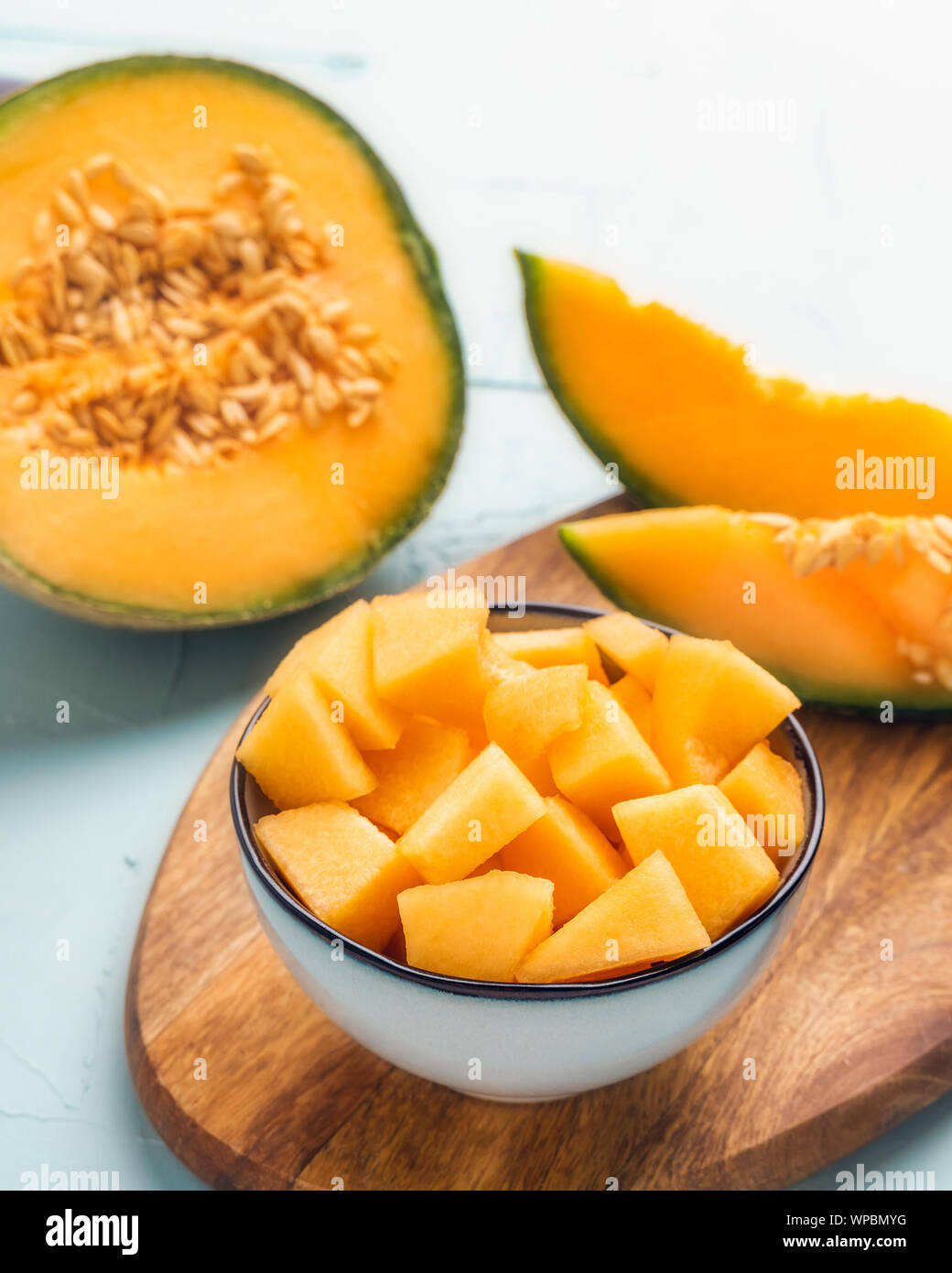 Fresh melon ready to eat vertical composition displayed on a bowl. Summer fruit food. Stock Photo