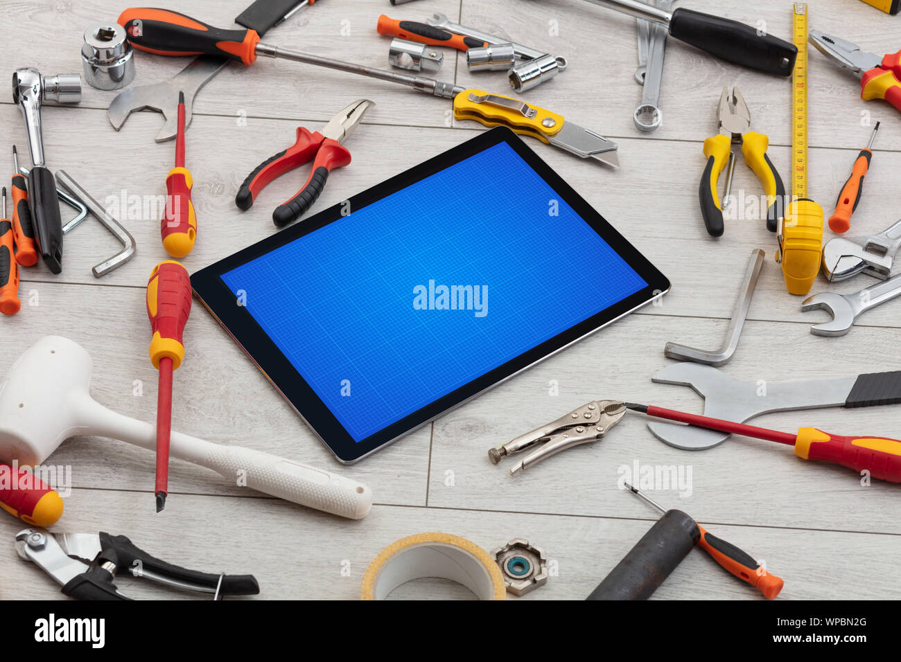 Household tools and tablet with grid screen concept Stock Photo