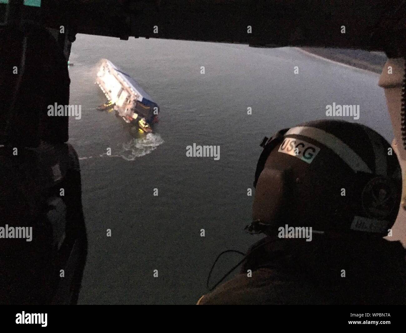 Coast Guard crews and port partners respond to a disabled cargo vessel with a fire on board September 8, 2019, in St. Simons Sound, Georgia. At approximately 2 a.m., Coast Guard Sector Charleston watch standers were notified of the M/V GOLDEN RAY, a 656’ vehicle carrier, listing heavily in the St. Simons Sound with a total of 24 people on board; including 23 crew members and 1 pilot. (U.S. Coast Guard photo) Stock Photo