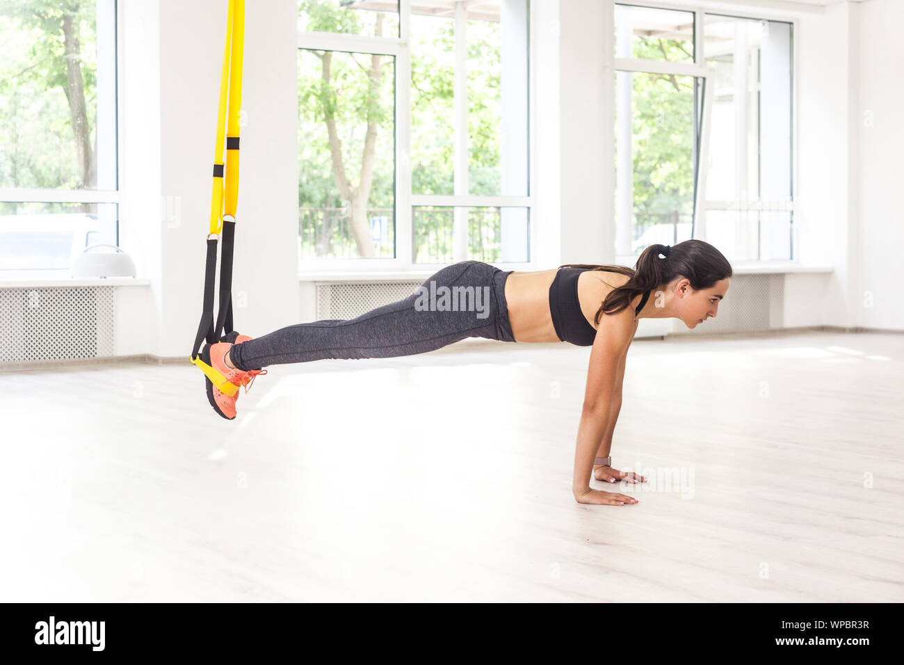 Side view portrait of young muscular woman wearing black top and