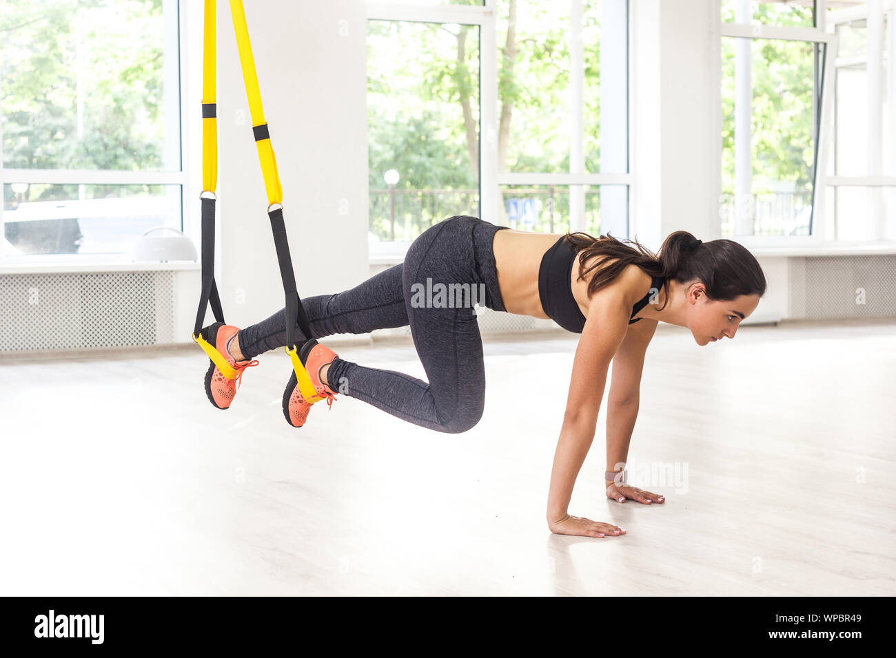 Side view portrait of young muscular woman wearing black sportswear