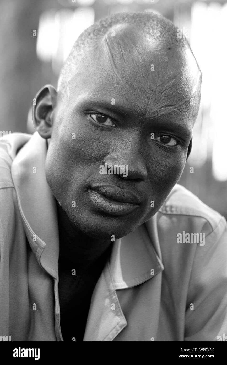 MANGALLA, SOUTH SUDAN-JUNE 23, 2012: An unidentified man has tribal scarification on his face in this illustrative editorial taken near Mangalla, Sout Stock Photo