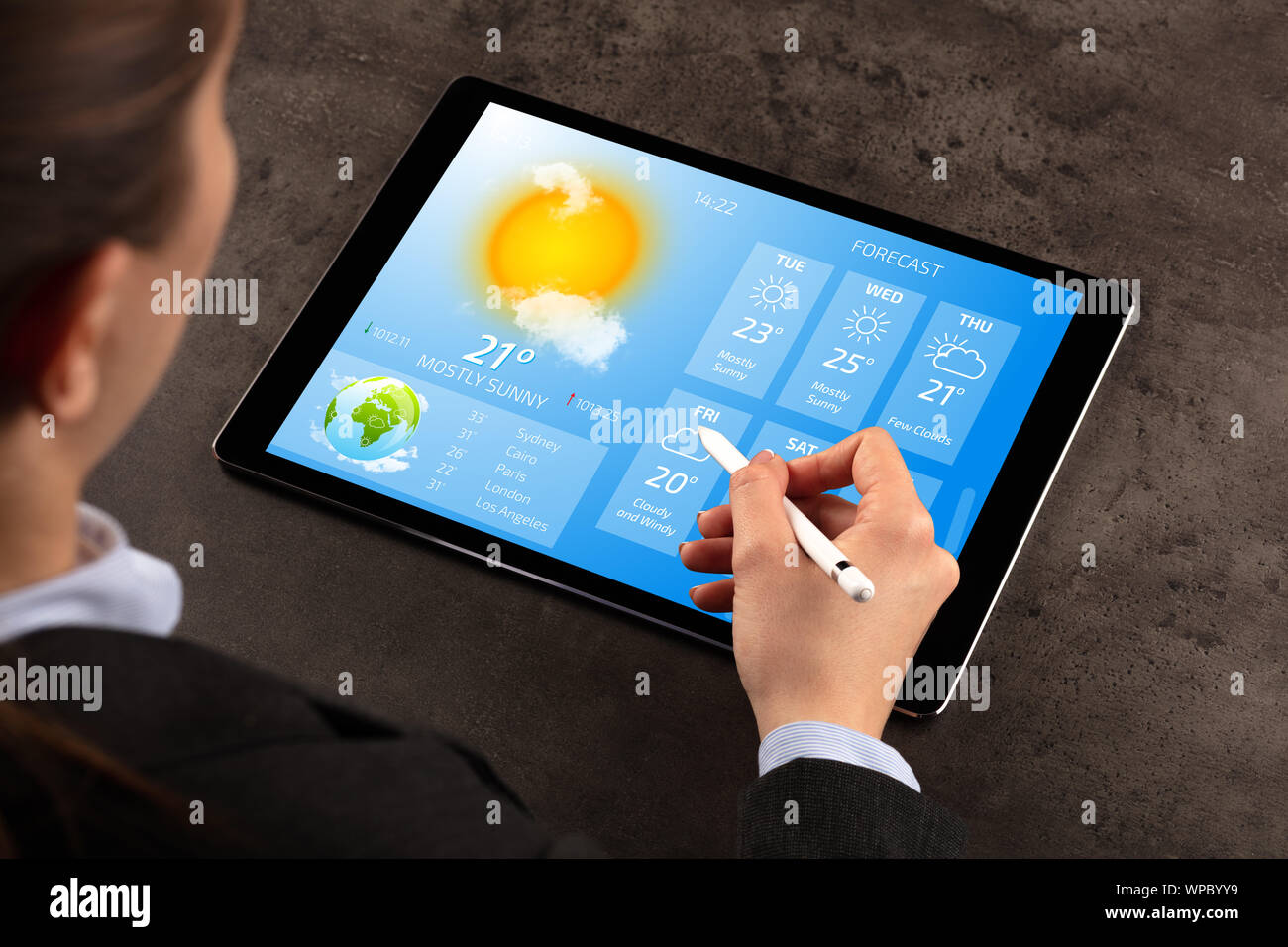 Business woman checking weekly weather forecast on tablet Stock Photo ...