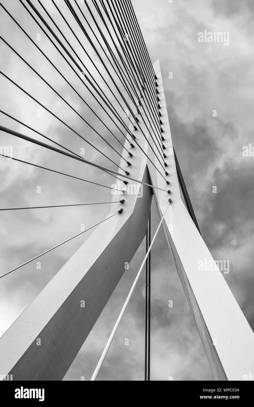 Pylon of Erasmusbridge against cloudy sky in black and white. It is combined cable-stayed and bascule bridge in the centre of Rotterdam, Stock Photo