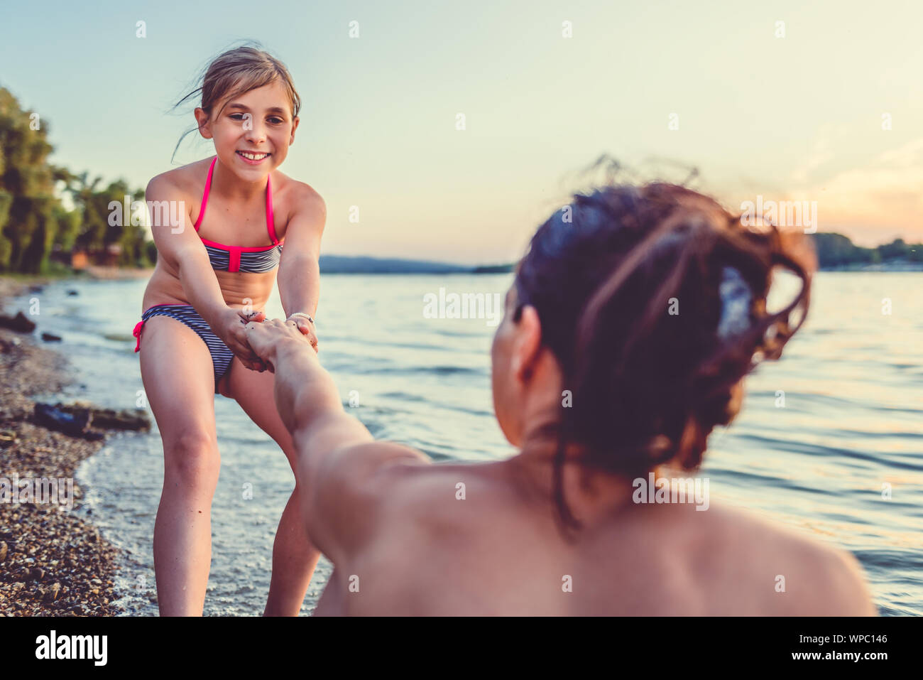 Mother and daughter enjoying on the beach Stock Photo