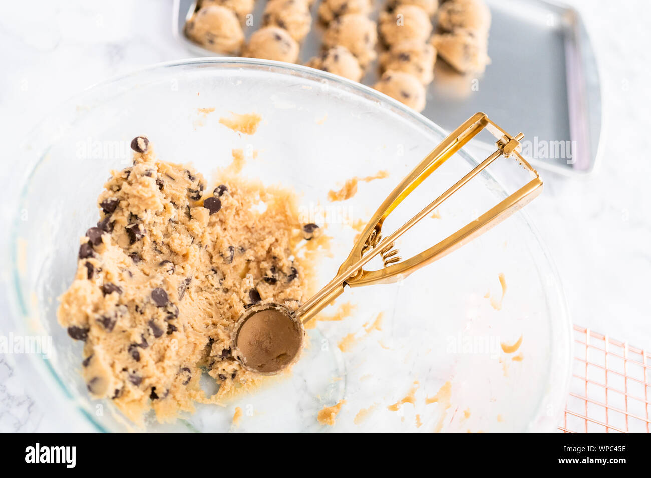 Homemade cookie dough with chocolate chips in a glass mixing bowl Stock ...