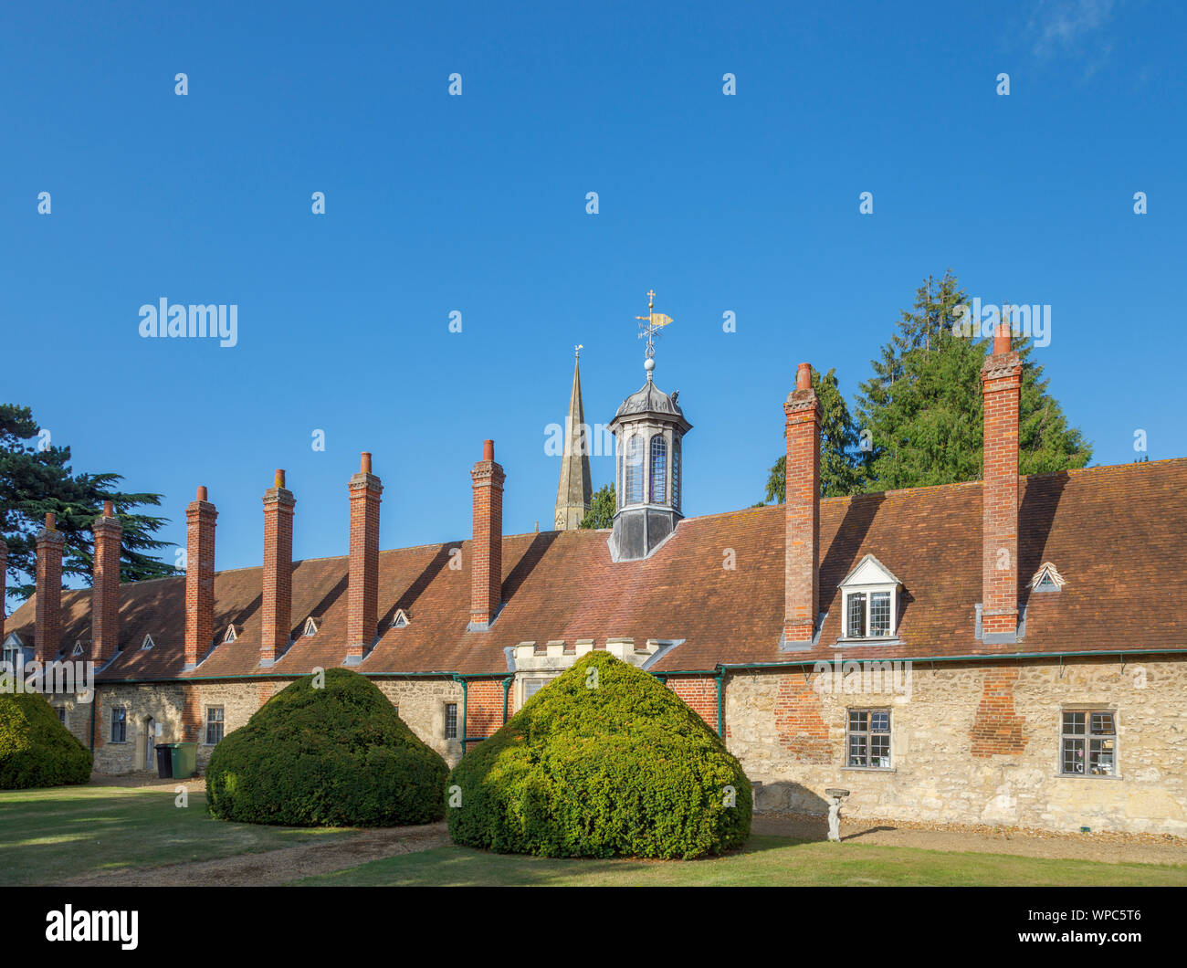 Rear of Long Alley Almshouses with roof lantern and spire of St Helen's