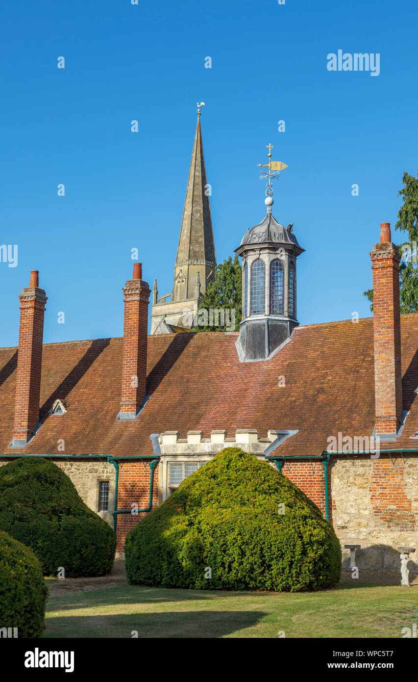 Rear of Long Alley Almshouses with roof lantern and spire of St Helen's Church, Abingdon-on-Thames, Oxfordshire, south-east England, UK Stock Photo