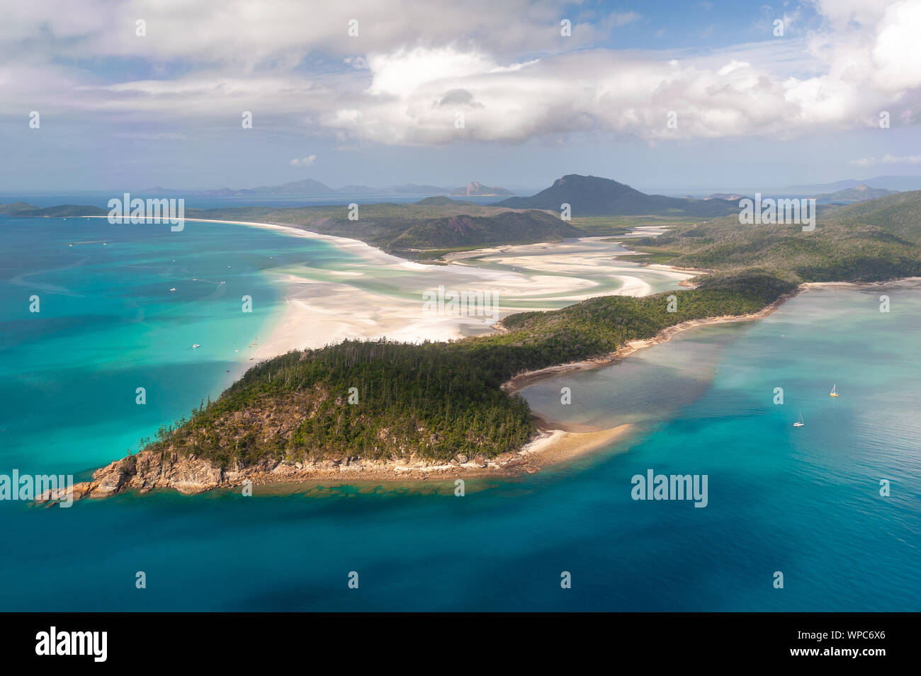 Aerial shot of Hill Inlet over Whitsunday Island - swirling white sands, sail boats and blue green water make spectacular patterns Stock Photo