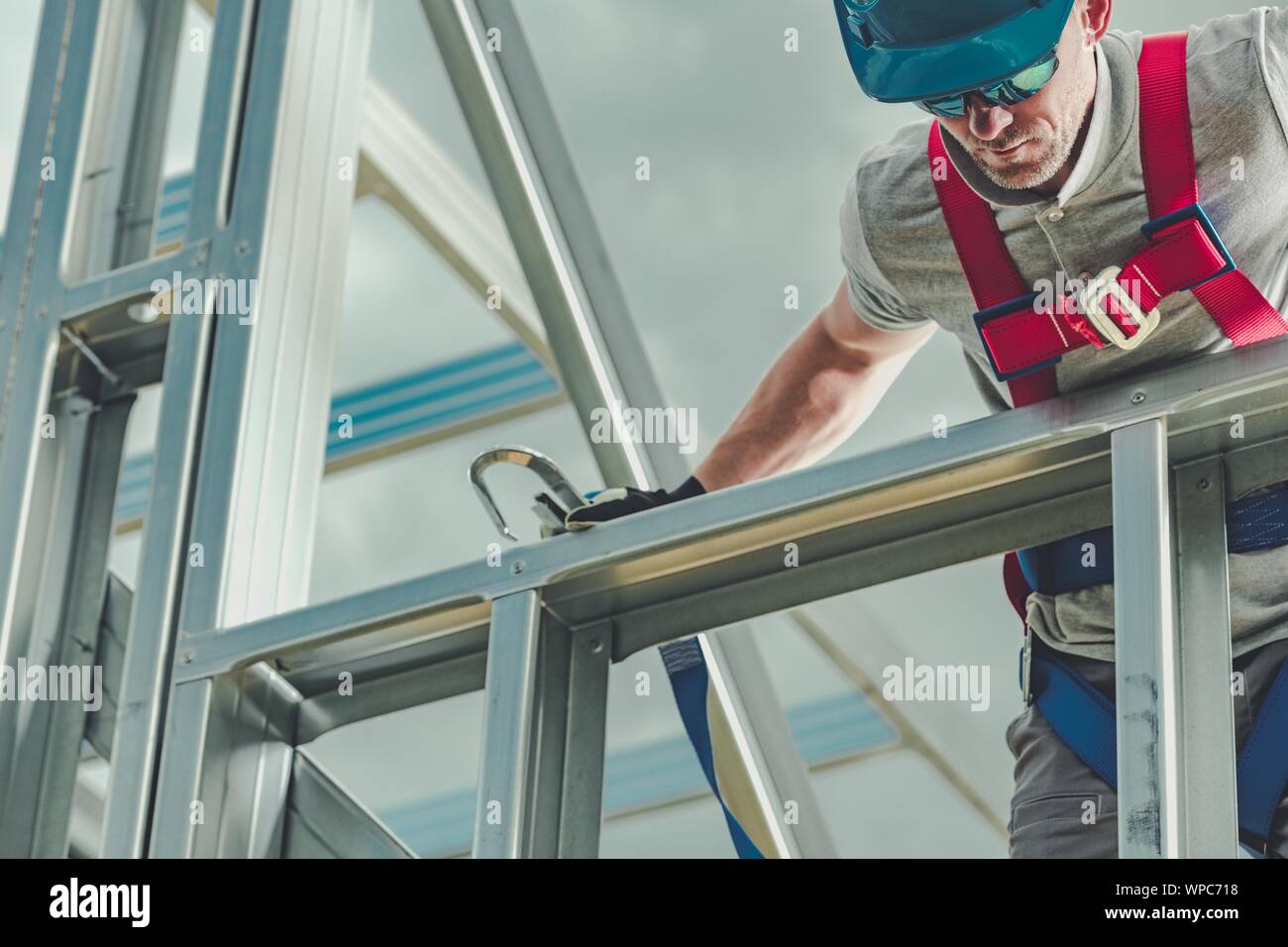 Construction Industry Work. Caucasian Contractor and the Skeleton Steel House Frame. Stock Photo