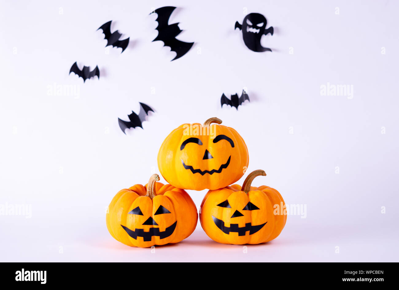 Halloween concept. orange pumpkins and flock of black paper bats on ...