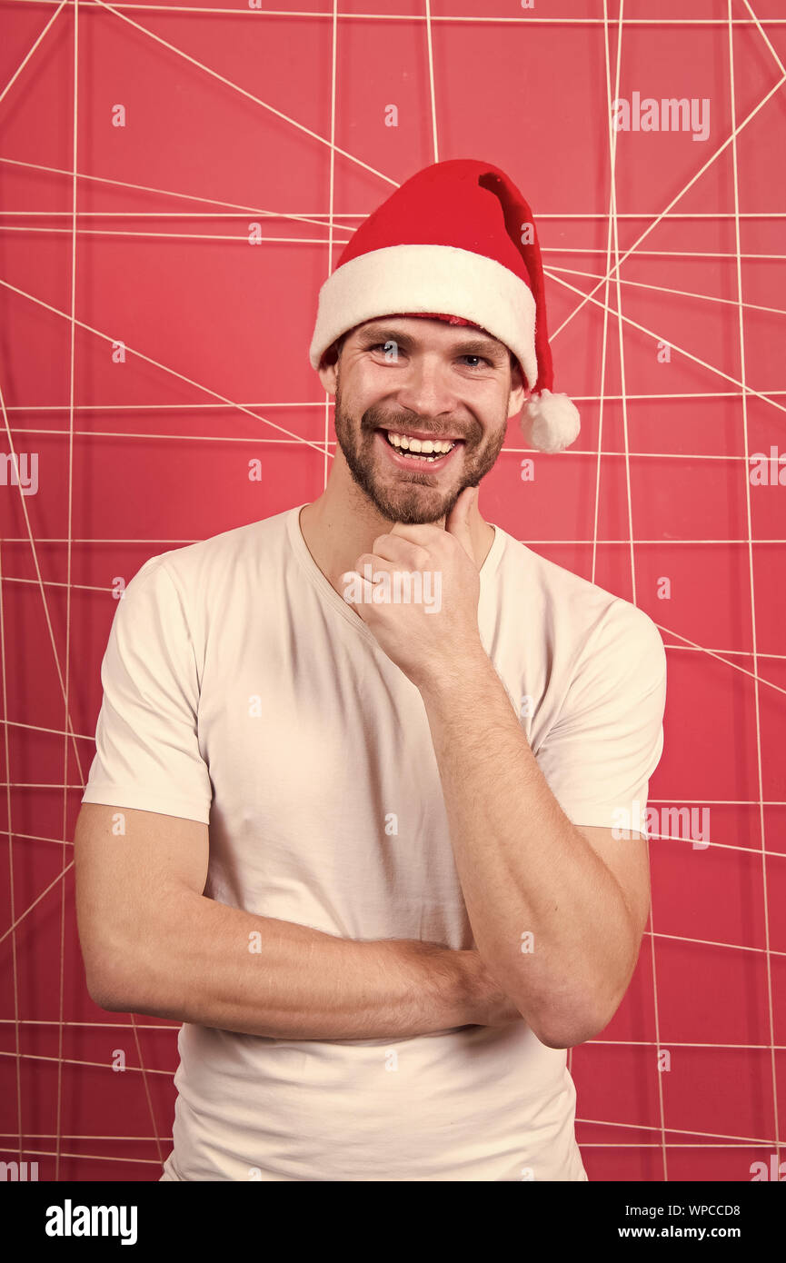 The morning before Xmas. man in santa hat hold christmas present. happy ...