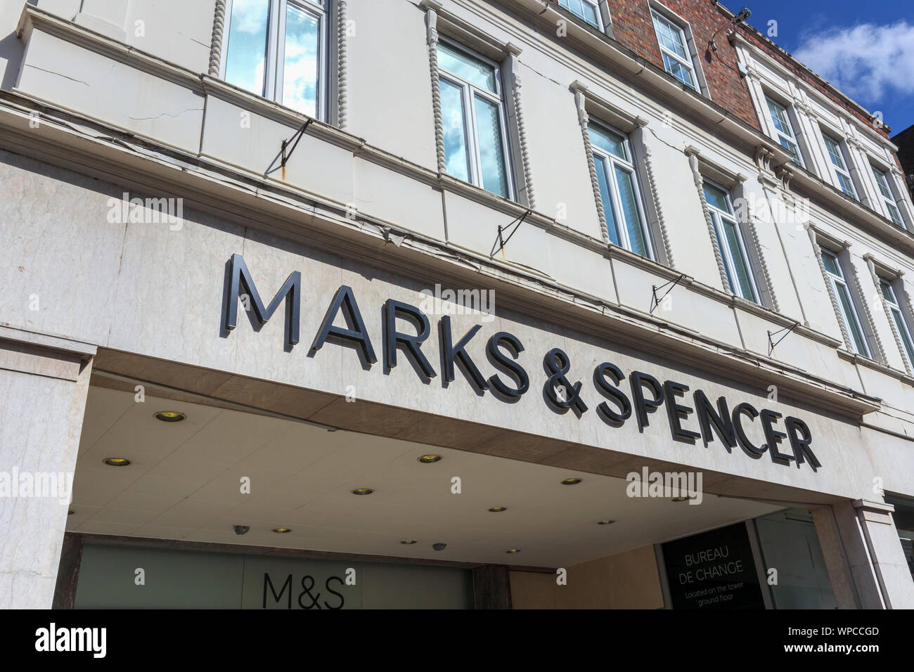 Marks & Spencer name on the frontage above the entrance to its shop in High Street, Guildford, Surrey, south-east England, UK Stock Photo