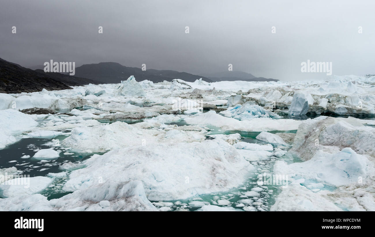 Drone image of Icebergs and ice from glacier in arctic nature landscape on Greenland. Aerial image drone photo of iceberg in Ilulissat icefjord. Affected by climate change and global warming. Stock Photo