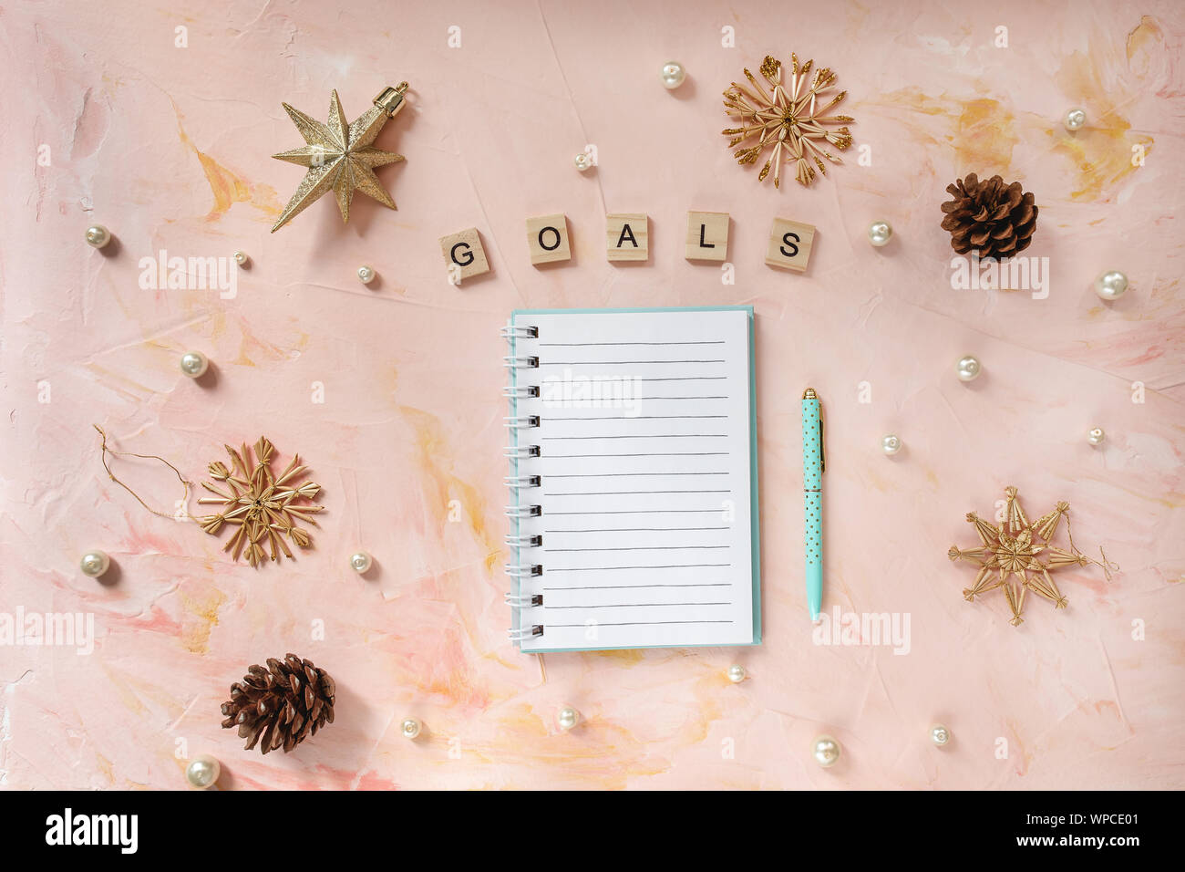 Goals Word And A Notepad Pen And Christmas Decoration On A Desk