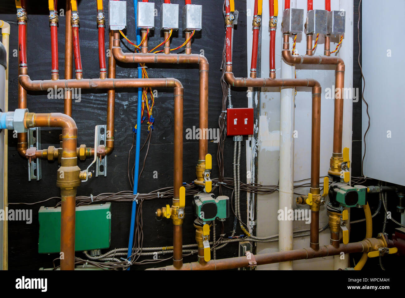 Heating system's copper pipes with ball valves on pipes collector of underfloor heating system