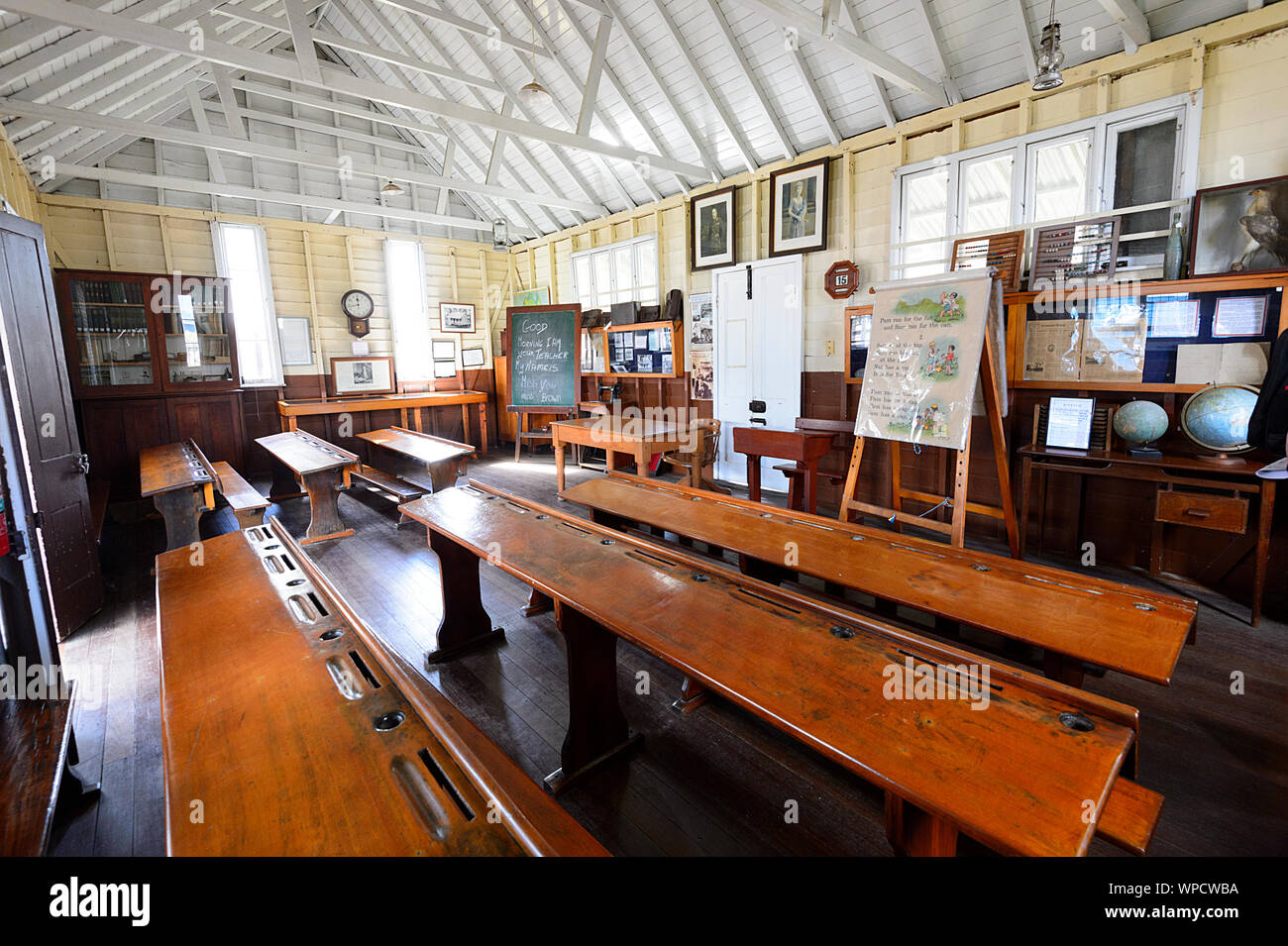 Rows of desks in an old classroom at Beenleigh Historical Village and Museum, Queensland, QLD, Australia Stock Photo