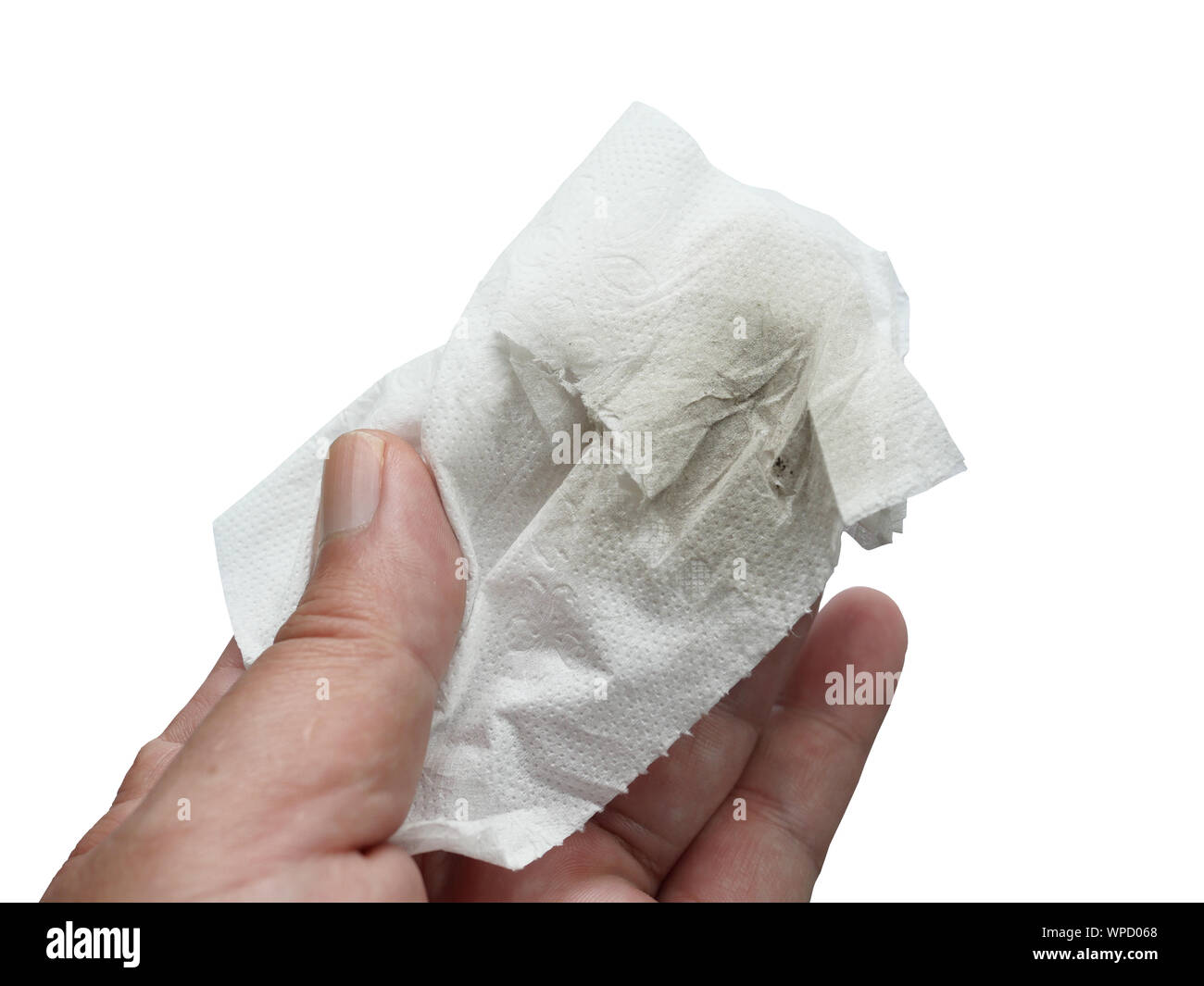 Black stain on paper towel in the hand isolated on white background