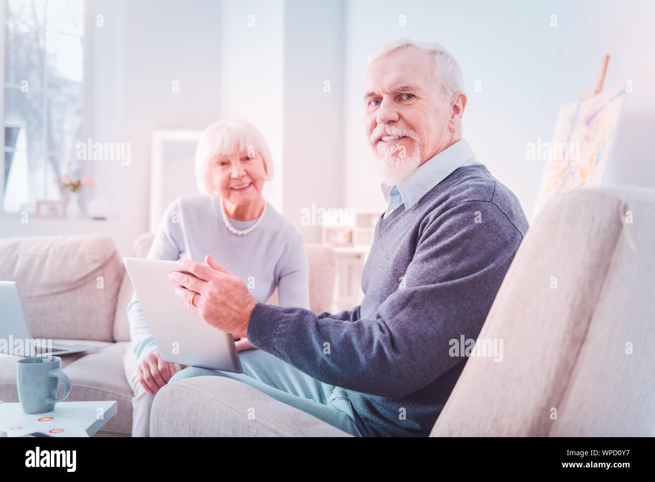 Beaming pensioners feeling happy while spending weekend together Stock Photo