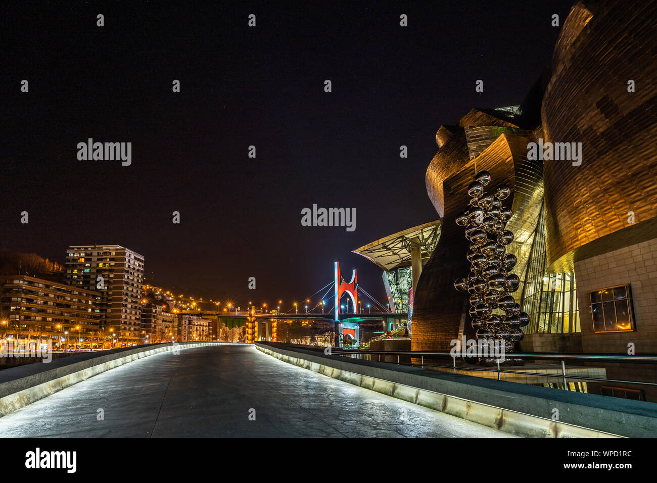 Night view of Guggenheim Museum with the sculpture Tall Tree and the Eye by Anish Kapoor, Bilbao, Basque Country, Spain Stock Photo