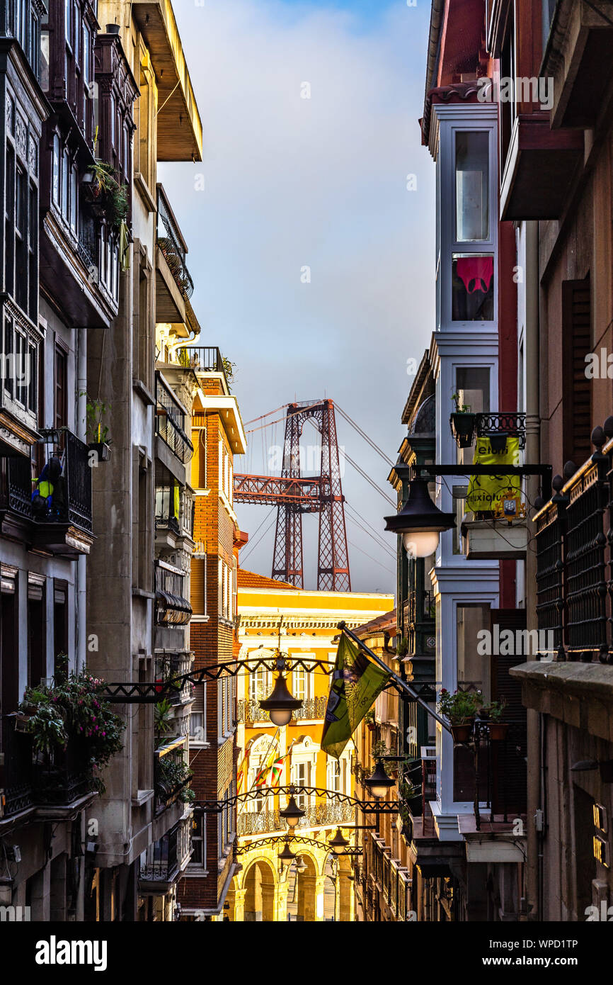Iron tower of the Vizcaya Bridge emerging between the buildings of Portugalete, Basque Country, Spain Stock Photo