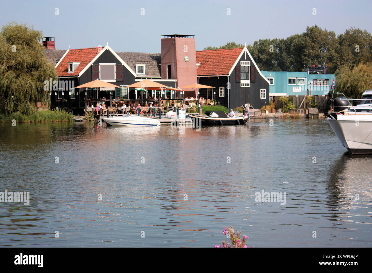 People enjoying outdoor dining in Volendam on a warm sunny day in summer. Volendam, North-Holland, The Netherlands Stock Photo