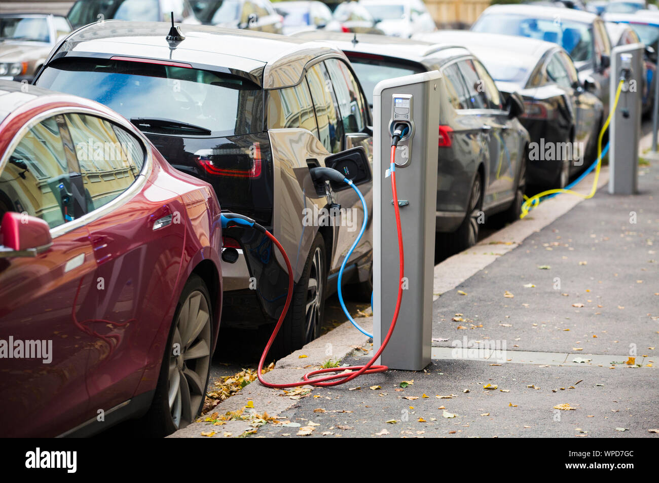 Charging modern electric cars (new energy vehicles, NEV) on the street station Stock Photo