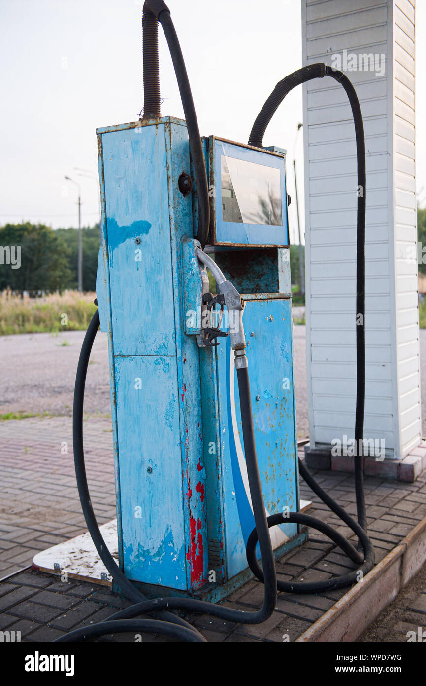 Old abandoned fuel station, gas station on secondary provincial road, fuel dispenser is broken. vintage gasoline column. Oil pollution of the earth. O Stock Photo