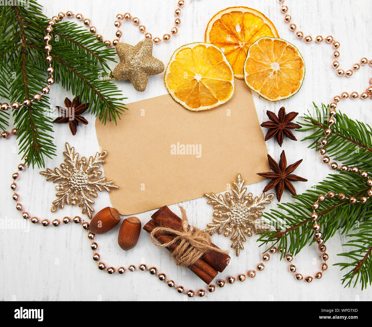 Christmas Tree With Baubles And Dry Oranges 0n A Old Wooden