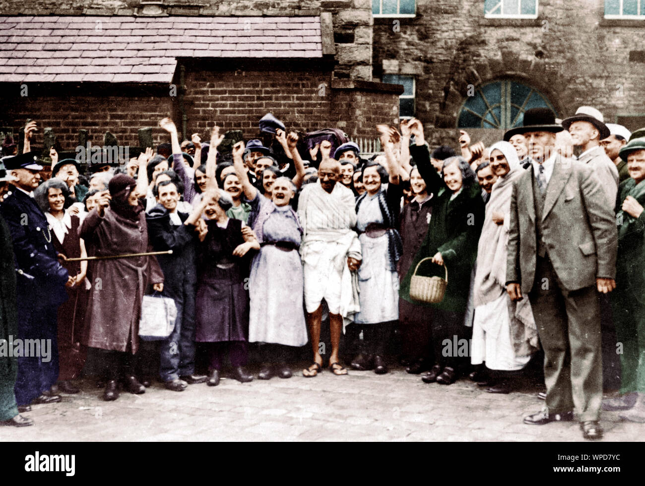 Mahatma Gandhi and cheering mill workers while leaving one of textile mills, UK, September 26, 1931 Stock Photo