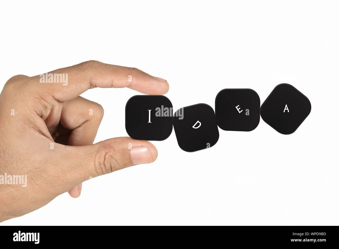 Person's hand with four cubes making text idea Stock Photo