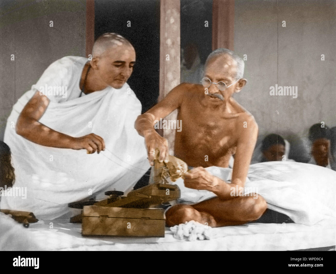 Mahatma Gandhi assisted by Mirabehn, repairing spinning wheel, Wardha, Maharashtra, India, Asia, 1936 Stock Photo