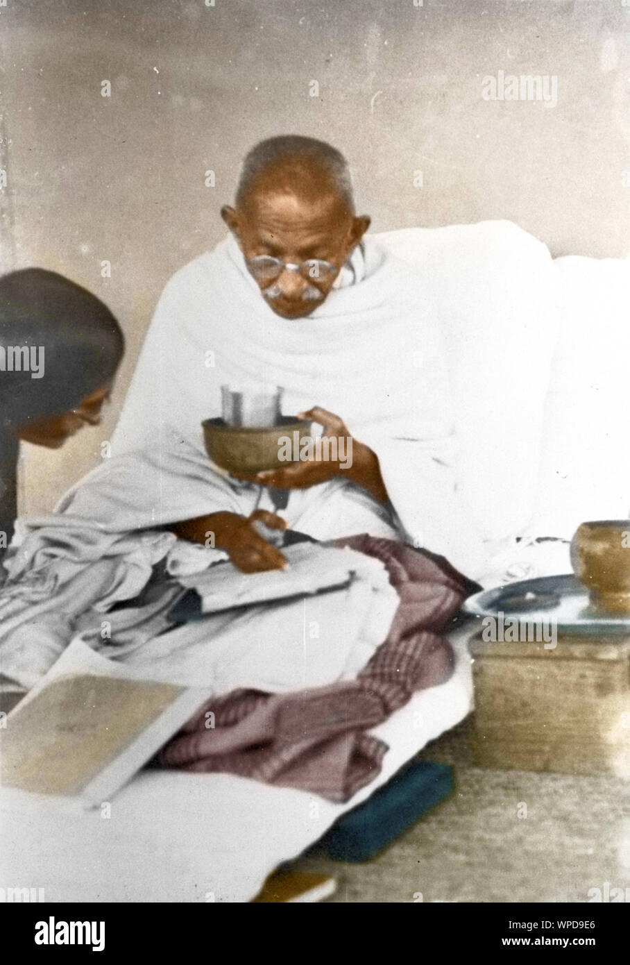 Mahatma Gandhi having completed meals, reading and talking, Wardha, India, Asia, 1936 Stock Photo