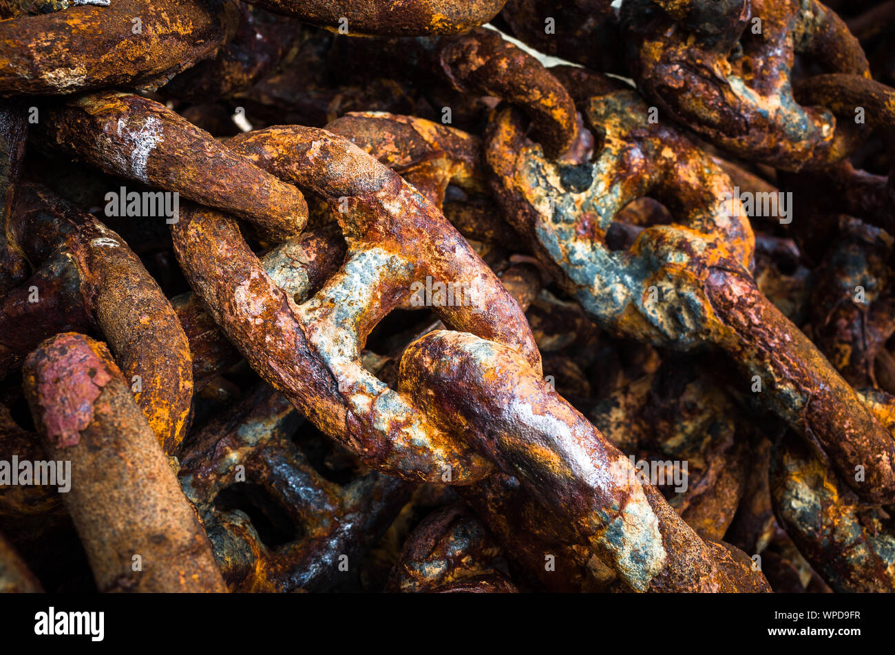 Old corroded thick iron chain background. Stock Photo