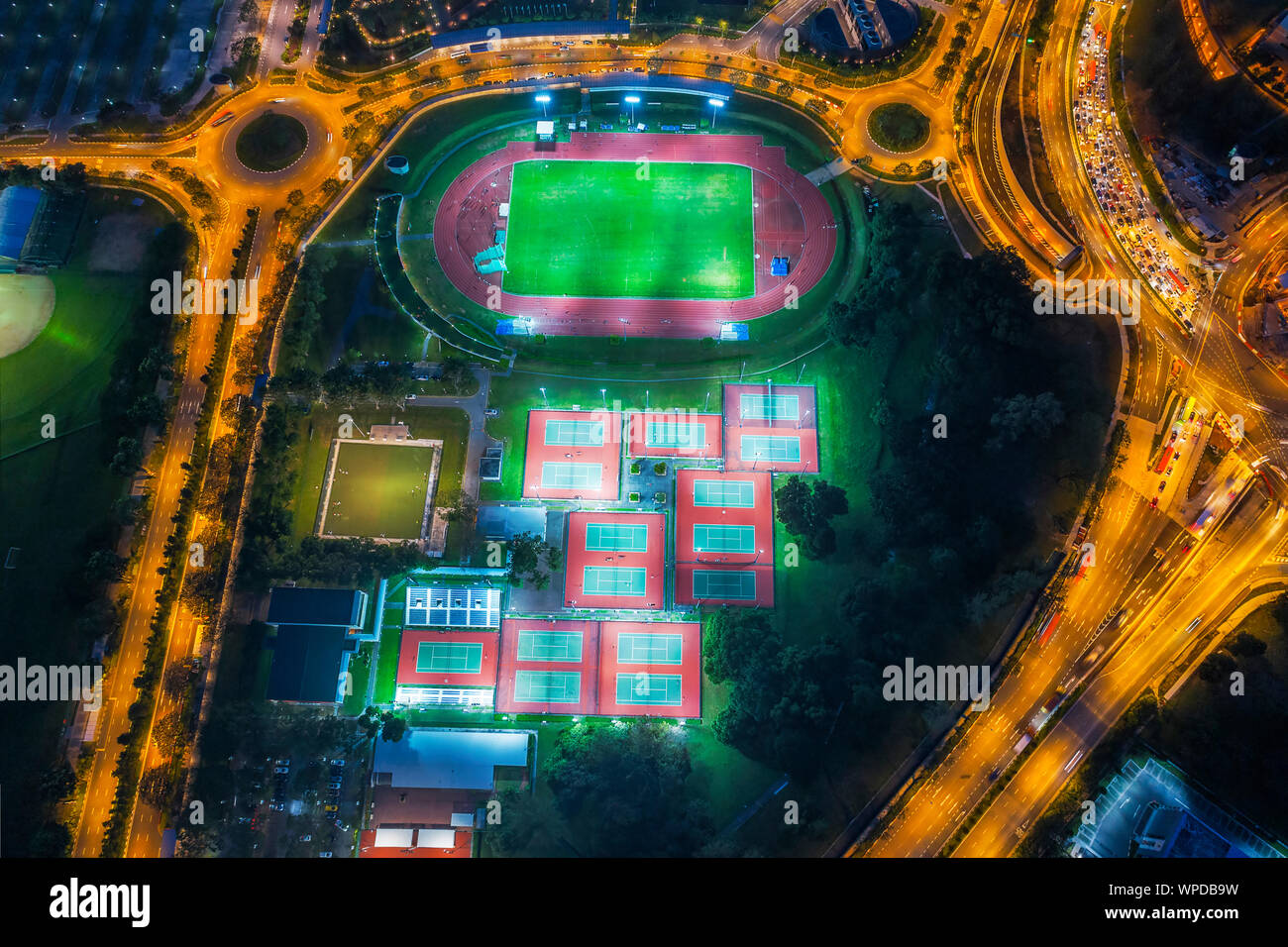 Aerial view of football stadium and tennis courts in the middle of
